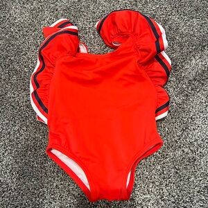 Red one piece with ruffle sleeve detailing